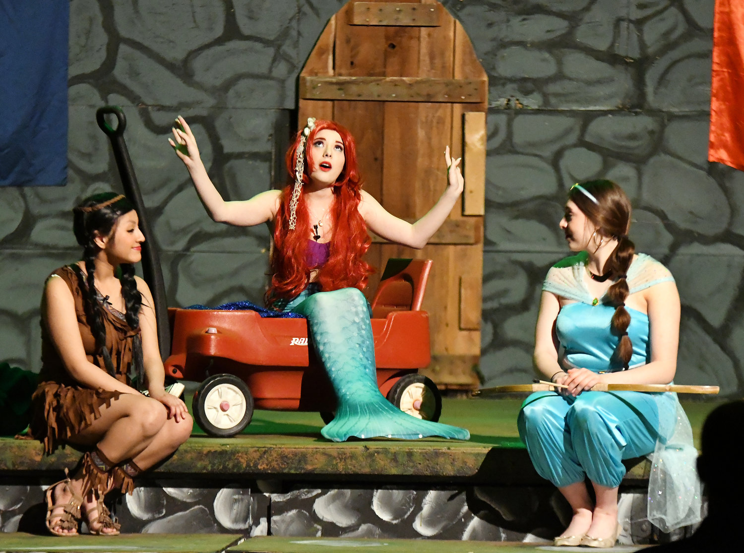 Alexia Alexander (The Little Mermaid, center) sings as Marina Kitchell (Indian Princess) and MaKenzy Pigg (Princess from Aladin) listen.